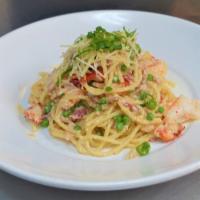 Lobster Carbonara  · Spaghetti, egg-parmesan cream sauce, claw meat, rock shrimp, bacon, peas.