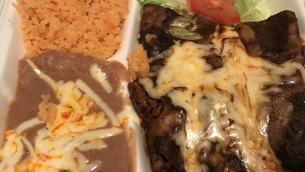 Enchiladas · Three hand-rolled tortillas stuffed with your choice of filling, covered in your choice of sauce, and topped with melted cheese. Served with rice, beans, and choice of corn or flour tortillas. Includes house salad.
