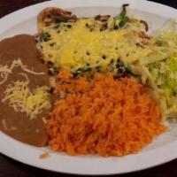 Pechuga Con Queso · Seasoned chicken breast topped with melted cheese. Served with rice, beans, and choice of co...