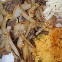 Bistec Encebollado · Grilled steak and onions. Served with rice, beans, and choice of corn or flour tortillas. In...
