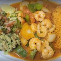 Camarones A La Mexicana · Shrimp seasoned and stuffed with a bell or jalapeño pepper, onion, and tomato. Served with r...