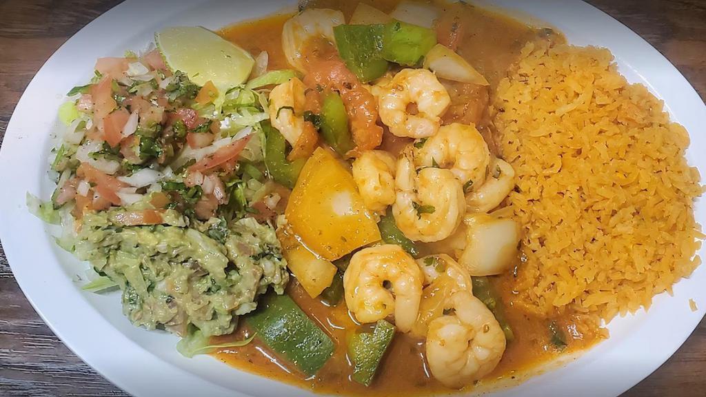 Camarones A La Mexicana · Shrimp seasoned and stuffed with a bell or jalapeño pepper, onion, and tomato. Served with rice, house salad, pico De gallo, and guacamole.