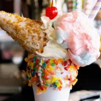 The Unicorn · vanilla cream rim rolled in fruity pebbles, vanilla glazed waffle cone sprinkled with gold d...