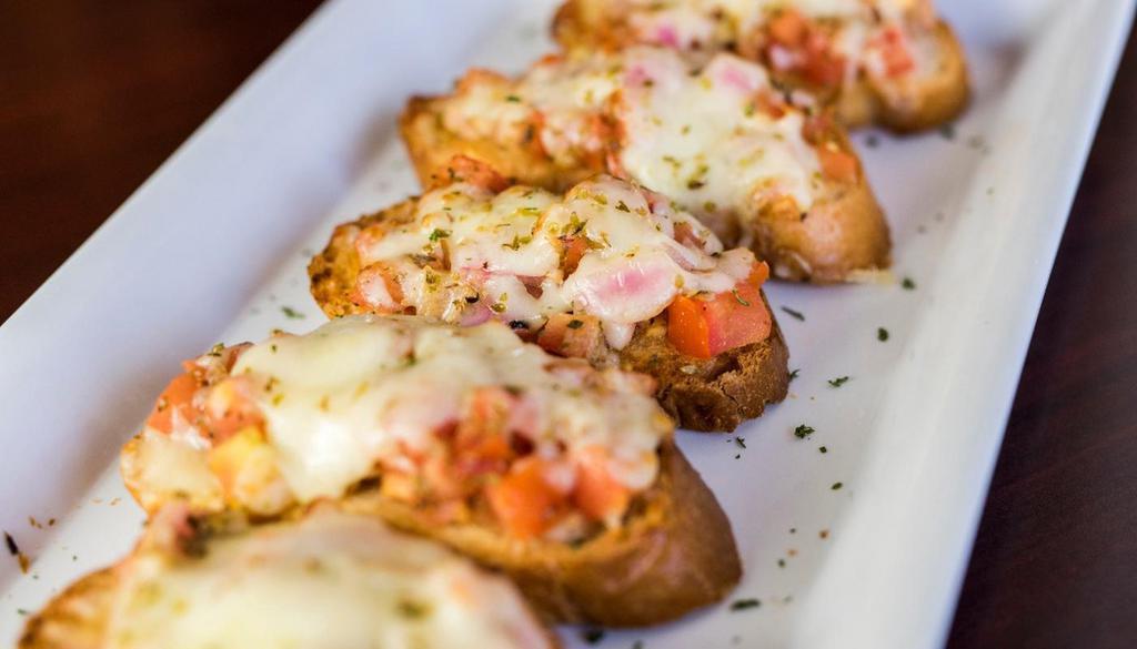 Toasted Bruschetta · A wonderful blend of Fresh Diced Tomato, Red Onion, Garlic, Basil and Italian Seasonings, toasted together on Italian Bread with Melted Mozzarella Cheese and sprinkled with Parmesan Cheese - five to an order