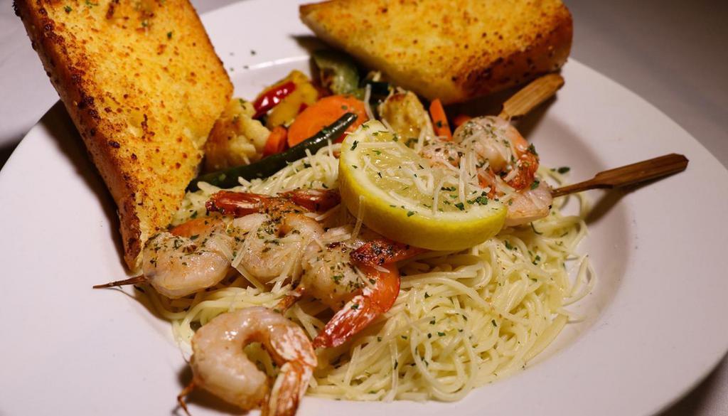 Shrimp Skewers · 2 Shrimp Scampi Skewers grilled to perfection, served over a Bed of Angel Hair Pasta sautéed with Garlic Butter Sauce. Served with a Blend of Italian Vegetables