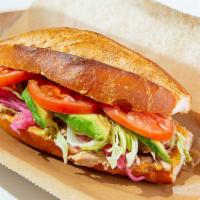 Slow Roast Pork Sandwich · Foodie favorite. Ecuadorian style pork, lettuce, tomato, avocado, pickled onions, and chipot...