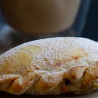 Sweet Empanada · Baked sweet empanada filled with a sweet cheese custard and sprinkled with powered sugar.
