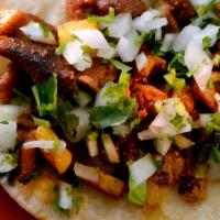 Loaded Al Pastor Taco · Al pastor with shredded cabbage, guacamole, pico de gallo, cotija, and cilantro loaded into ...