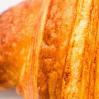 Plain Croissant · Inescapable French pastry, the croissant is rolled and shaped into a crescent. The texture i...