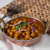 Chana Aloo · Garbanzos cooked with fresh potatoes and traditional punjabi spices. Served with saffron and...