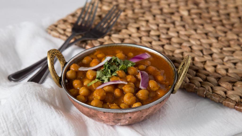 Chana Aloo · Garbanzos cooked with fresh potatoes and traditional punjabi spices. Served with saffron and basmati rice.