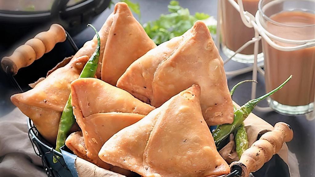 Vegetable Samosa (Two Piece) · Crispy fried pastry stuffed with spicy potatoes and peas served with tangy tamarind and spicy cilantro chutney.