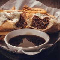 Prime Rib Dip · Shaved prime rib stuffed in a Milano roll then topped with melted provolone cheese. Served w...