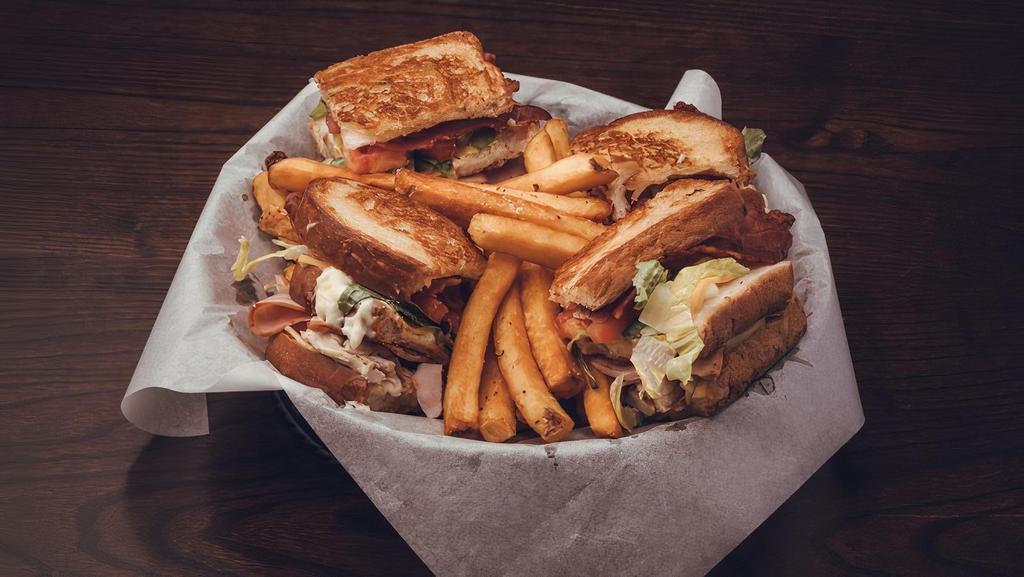 Clubhouse · Pulled chicken, shaved ham, smoked bacon, american, Swiss, honey mustard, mayo, lettuce & tomato triple stacked on toasted white bread.