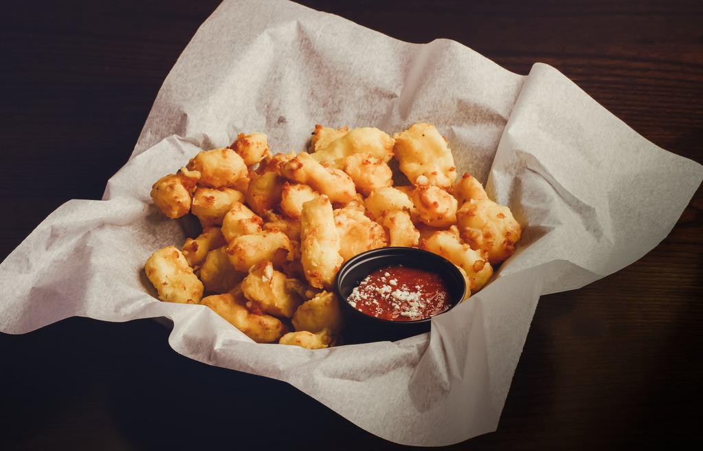 Cheese Curds · Wisconsin squeaky white cheddar cheese curds hand breaded & fried into gooey bites w/ choice of marinara or ranch.