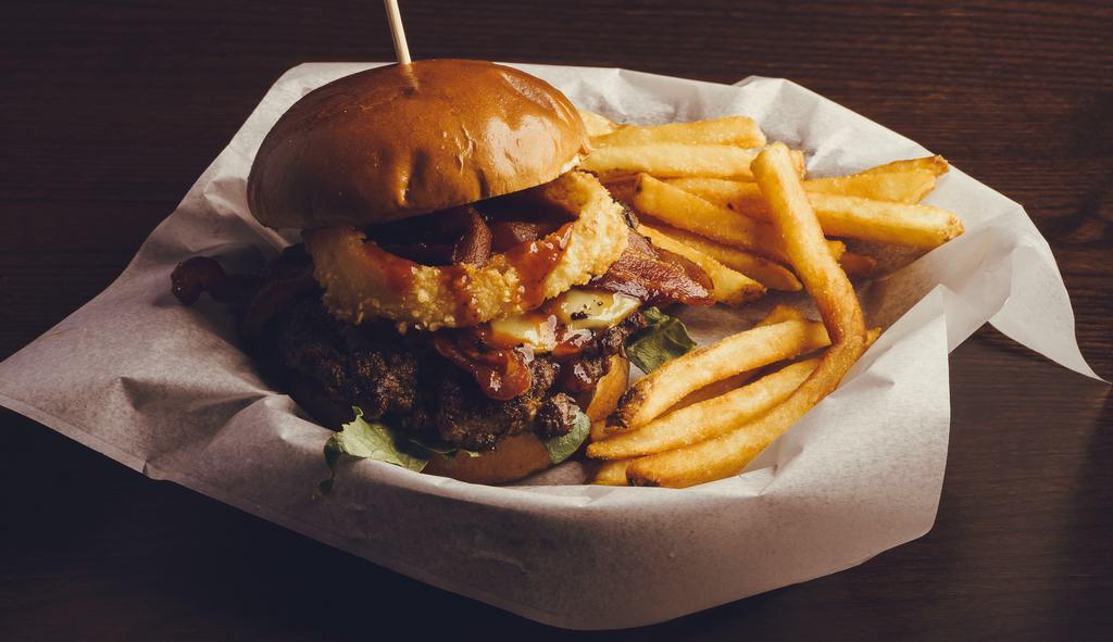 The Highnooner · 1/2 pound burger w/ honey whiskey BBQ sauce, smoked gouda cheese, smoked bacon, fried onion ring, Duke's mayo, lettuce, tomato & pickle on a brioche bun.