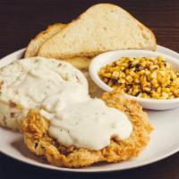 Chicken Fried Steak · Hand breaded & fried sirloin steak & redskin mashed potatoes covered in country gravy and ch...