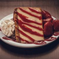 Strawberry Cheesecake · A colossal slice of New York Cheesecake topped with strawberry puree, strawberries and whipp...