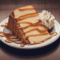 Salted Caramel Cheesecake · A colossal slice of New York Cheesecake topped w/ caramel sauce and sea salt.