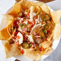 Nachos · Melted Pepper jack cheese, jalapenos, pico, sour cream and topped with green onions.
