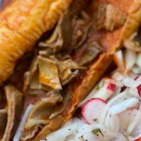 Tortas Ahogadas · Wet mexican sandwich with onion/lime mixture and carnitas. (Mexican Pork)