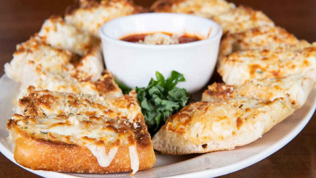 Garlic Cheese Bread · Our homemade bread toasted with garlic butter, mozzarella and Parmesan cheese, and Italian seasonings. Served with a side of pizza sauce.