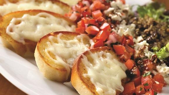 Bruschetta · Toasted garlic rounds topped with melted mozzarella and parmesan cheeses. Served with olivetta, feta, and tomato bruschetta. Drizzled with balsamic glaze.