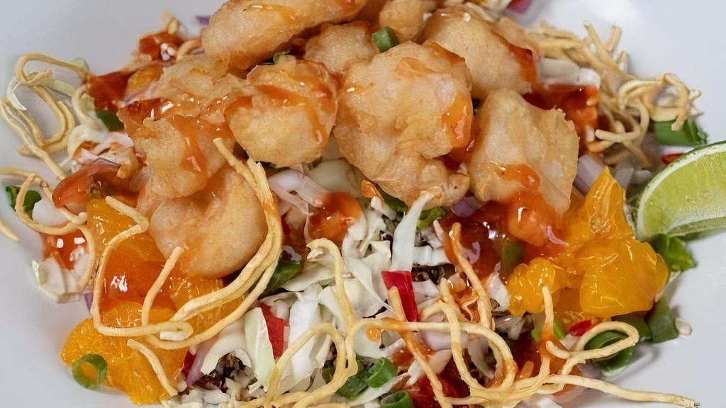 Peking Shrimp Bowl · Tempura battered shrimp served over a bed of brown rice quinoa, cabbage, roasted jalapeños, red peppers, red onions, and mandarin oranges. Topped with Peking Zing sauce, green onions, cilantro, and fried noodles.