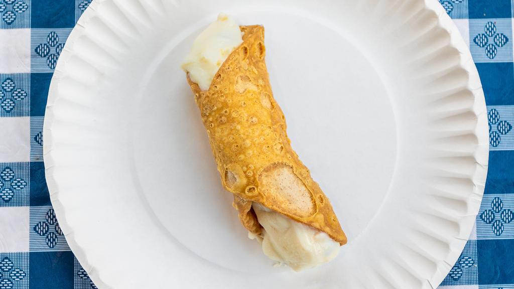 Cannoli · An Italian pistachio pastry shell filled with chocolate chips and a sweet creamy filling.