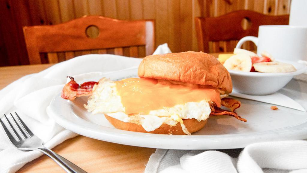 Big Breakfast Sandwich · Two over-hard eggs, bacon, cheddar and chipotle mayo on a toasted brioche roll. Served with your choice of side.