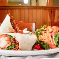 Monterey Ranch Chicken Wrap · Crispy or grilled chicken breast, monterey jack, bacon, lettuce, tomato and a side of house ...