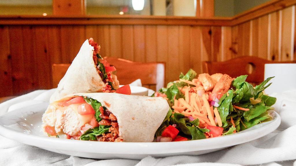 Monterey Ranch Chicken Wrap · Crispy or grilled chicken breast, monterey jack, bacon, lettuce, tomato and a side of house ranch.
