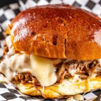 Brisket Sandwich (1/2 Lb Meat) · Slow-cooked brisket, Swiss cheese, house sauce, caramelized onions, BBQ, coleslaw, and pickl...