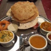 Vegetarian Thali · Idli or wada, vegetable curry(2), Poori(2), Rice, Sambhar and Gulab Jamun(1)