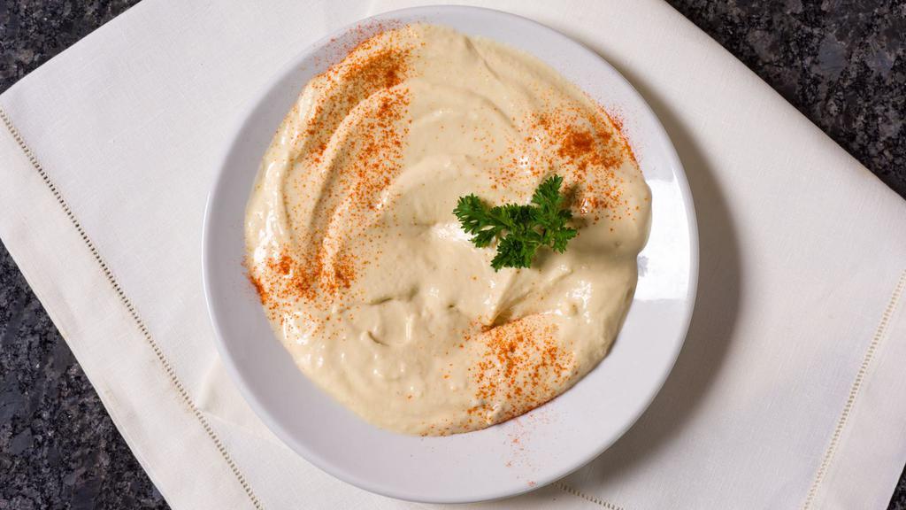 Hummus · Vegetarian. Chickpeas blended with tahini sauce, garlic and lemon.