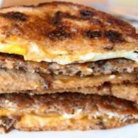 Eggy Melt · Hamburger patty, 2 fried eggs, bacon. American cheese, tomato on white bread.