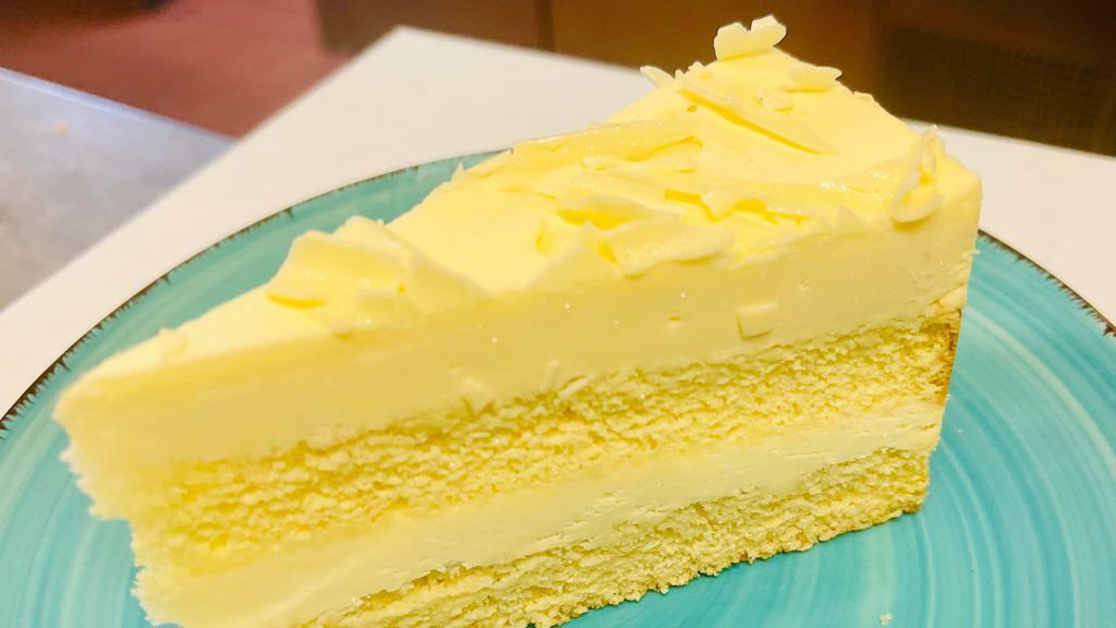 Lemon Mascapone Cake · Made with a moist lemon cake, lemon curd and a smooth and creamy whipped mascarpone frosting! It's light, yet sweet and tart and so darn good!