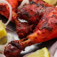 Chicken Tandoori · Half Chicken with bone marinated in yogurt, herbs, then baked in a clay oven.