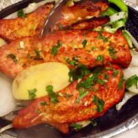 Fish Tandoori · Swordfish marinated with yogurt, mild spices, herbs, then baked in a clay oven.