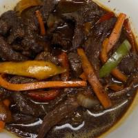 Pepper Steak · Stew beef in light browning sauce with bell peppers, onions & garlic.