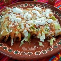 Enchiladas Rojas · Three rolled corn tortillas with shredded beef, onions, topped with red or green tomato sauc...