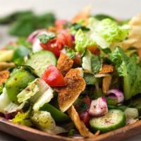Fattoosh Salad · Traditional Mediterranean salad tossed with toasted pita chips and our homemade olive oil an...