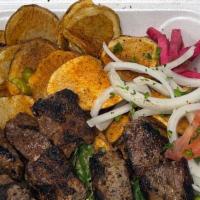 Beef Kabob Plate · Marinated and char grilled. Your choice of tender beef. Served with soup or salad and choice...
