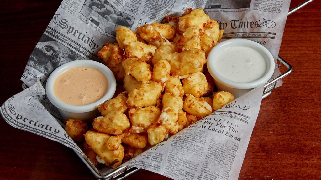 House Made Cheese Curds · A shareable portion of state fair style cheese curds lightly battered and served with ranch dressing and choice of signature dipping sauce.