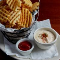 Seasoned Waffle Fries · Waffle cut potatoes fried to a golden crisp, dusted with our special blend of parmesan and s...