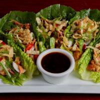 Thai Chicken Lettuce Wraps · Our fresh Asian slaw tossed in sesame lime with Thai peanut chicken. Topped with crispy wont...