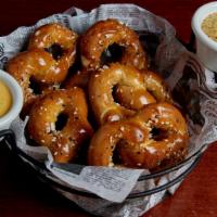 Tavern Seeded Pretzel · Five warm pretzels brushed with butter and dusted with a seeded spice blend. Served with bee...