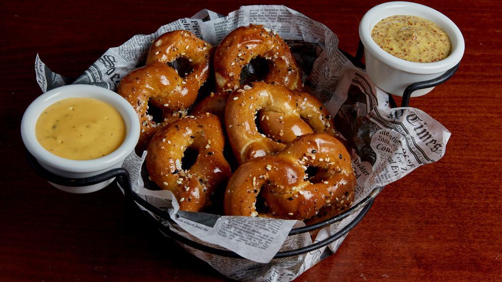 Tavern Seeded Pretzel · Five warm pretzels brushed with butter and dusted with a seeded spice blend. Served with beer mustard and cheesy jalapeño sauce.