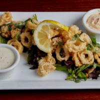 Lemon Basil Calamari · Tender calamari lightly fried for a delicate crunch. Set on a bed of spring greens and finis...