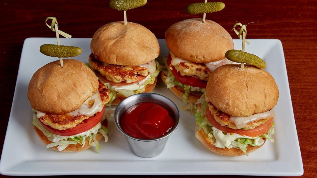 Chicken Littles · House made fresh ground chicken patties with garlic aioli, shredded lettuce, melted swiss, and sliced tomato. Served on grilled slider buns with speared cornichon.